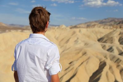 Rear view of teenage boy at desert