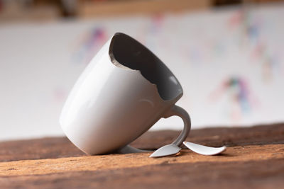 Close-up of broken cup on table