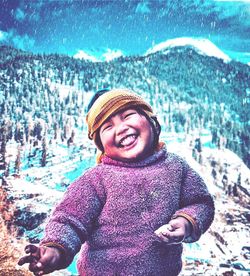 Portrait of smiling man standing in snow