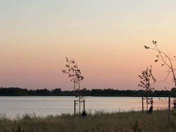 Scenic view of lake against sky during sunset