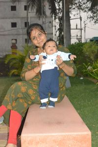 Happy mother and son with daughter in park