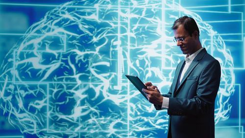 Portrait of businessman using mobile phone