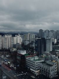 Cityscape against cloudy sky