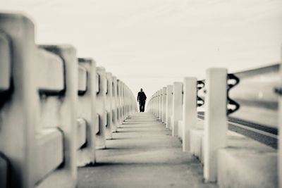 Rear view of man walking in corridor