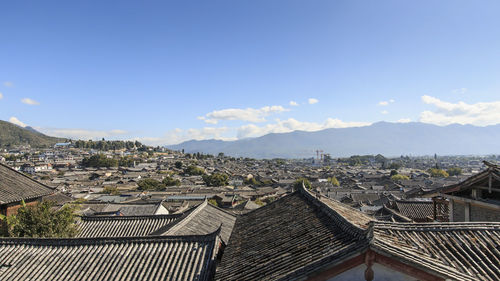 Traditional houses and mountains against sky