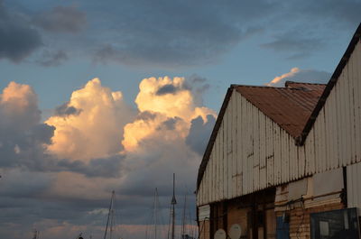Low angle view of houses against sky during sunset