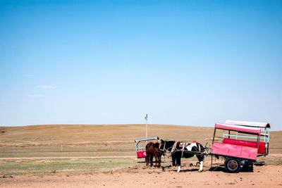 View of horse cart on field against sky