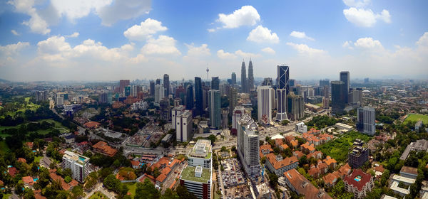 Cityscape against cloudy sky