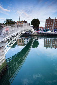 Bridge over river with buildings in background