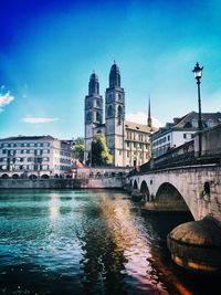 Bridge over river with buildings in background