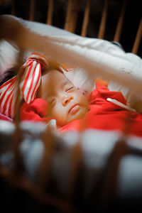 High angle view of baby girl lying on bed