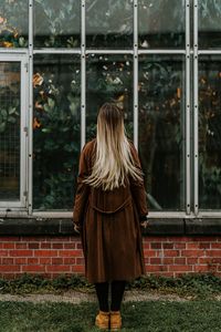 Rear view of woman standing by plants