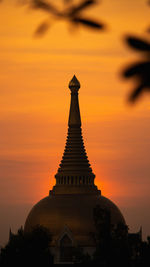 Low angle view of silhouette building against sky during sunset