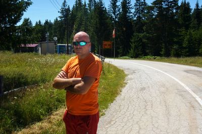 Full length of young man standing by road