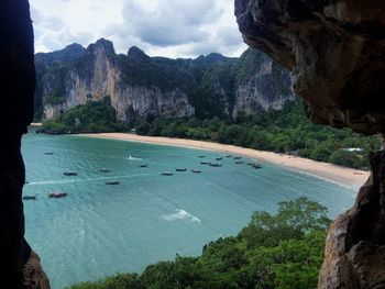 Scenic view of sea and mountains against sky