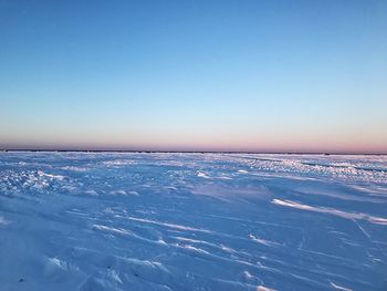Scenic view of frozen sea against clear blue sky