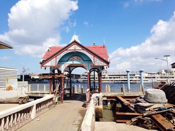 Pathway leading towards gazebo against lake