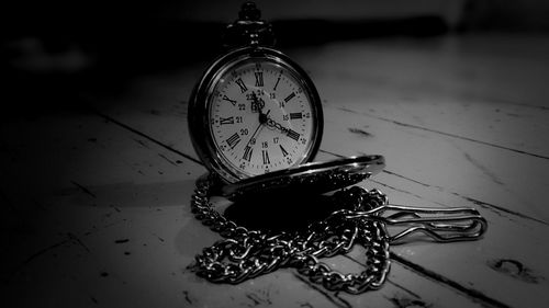 Close-up of clock on white wall