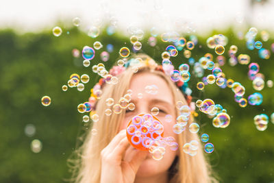 Portrait of beautiful woman with bubbles