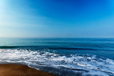 Scenic view of sea against clear blue sky