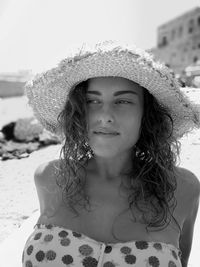 Portrait of young woman on sand at beach