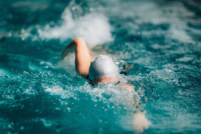 Recreational front crawl swimming in the pool.