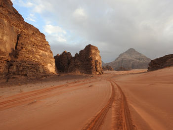 Panoramic view of desert road against sky