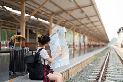 Rear view of woman standing in subway