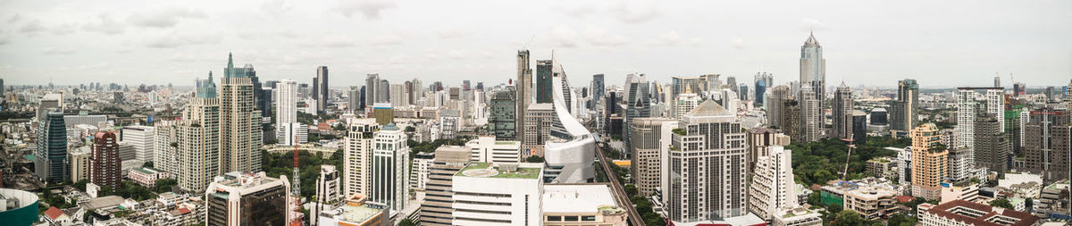 High angle view of modern buildings in city against sky