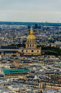 Aerial view of buildings in city against sky