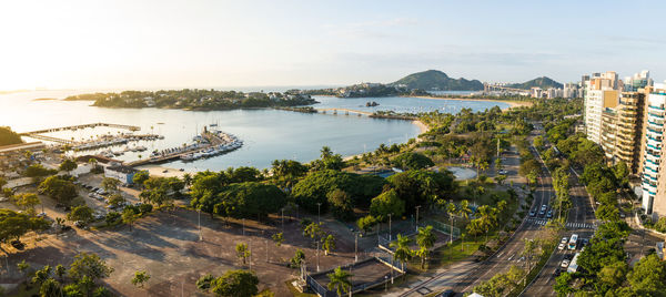 High angle view of city by sea against sky