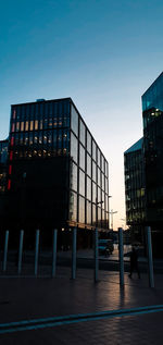 Low angle view of modern building against clear sky during sunset