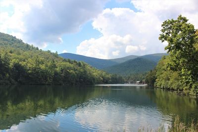 Scenic view of lake and mountains against sky