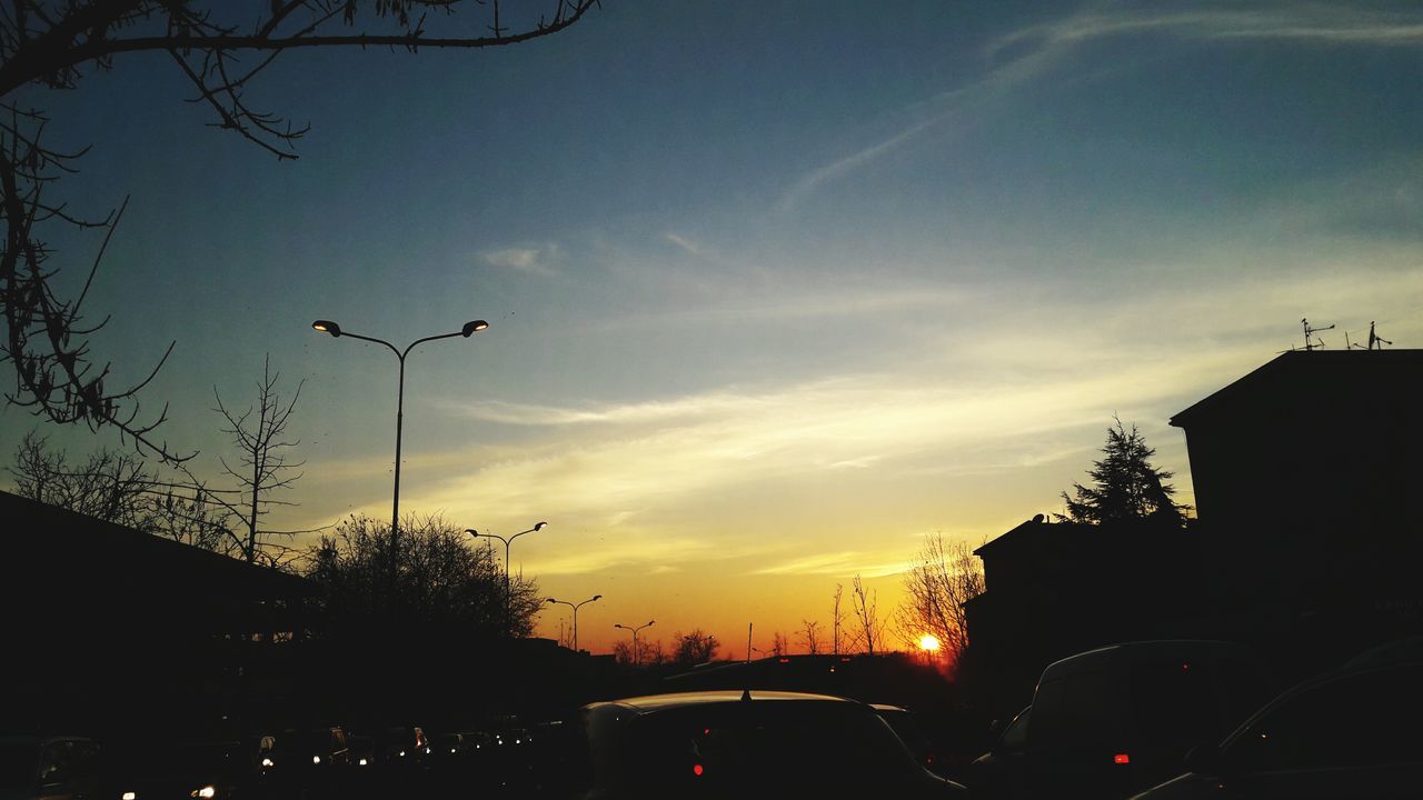 SILHOUETTE OF CARS AT SUNSET