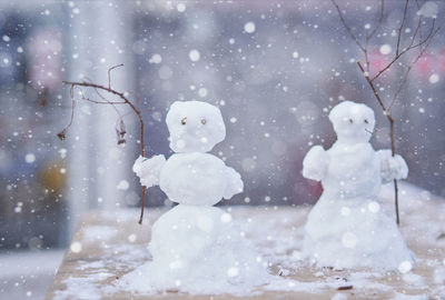 Close-up of snowmen on table