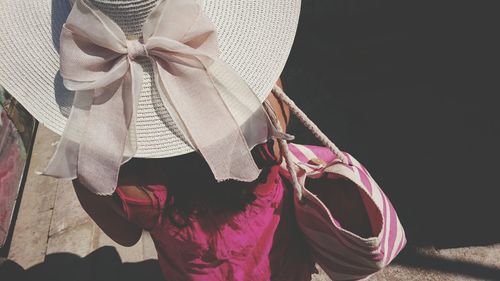 High angle view of woman wearing pink dress at beach