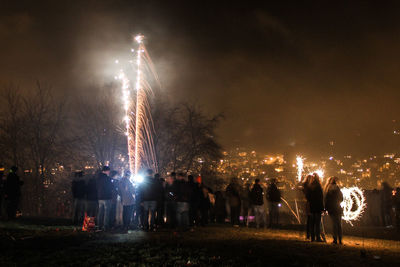 People enjoying fireworks at night