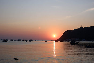 Scenic view of sea against romantic sky at sunset