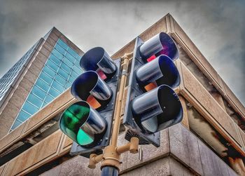 Low angle view of road sign against sky in city