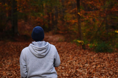 Rear view of man standing in forest