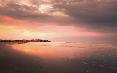 Scenic view of beach against sky during sunset