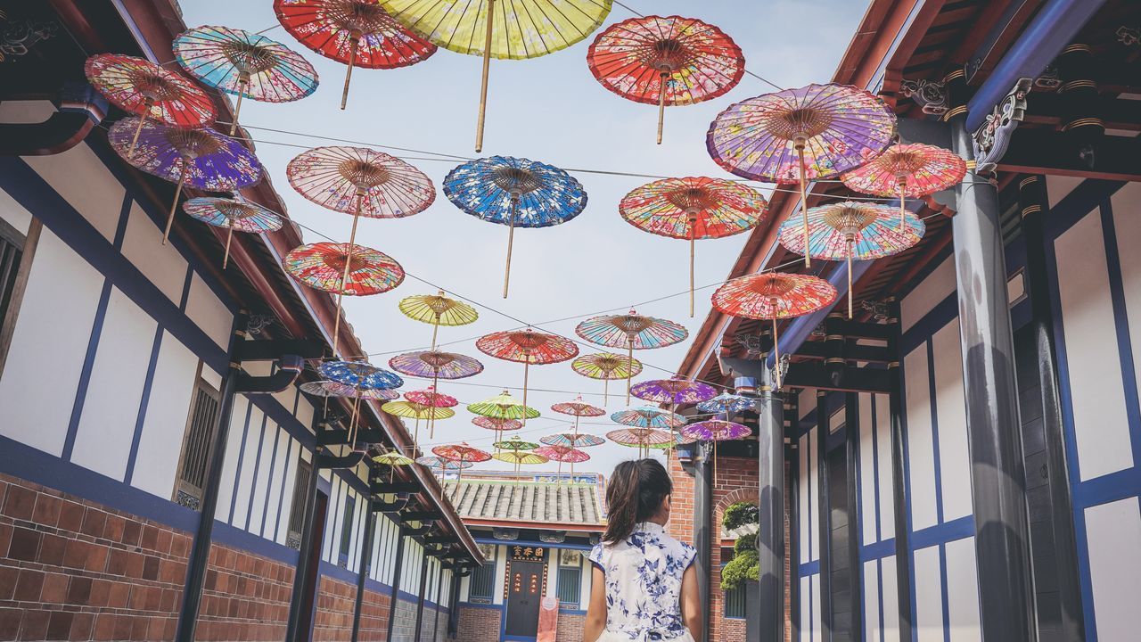 LOW ANGLE VIEW OF LANTERN HANGING IN CITY