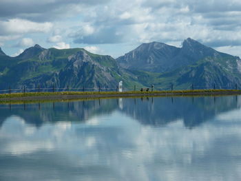 Scenic view of lake and mountains against sky