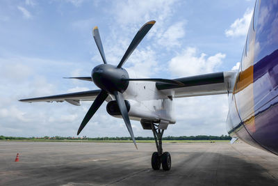 Airplane on runway against sky