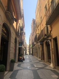 Narrow alley amidst buildings in city