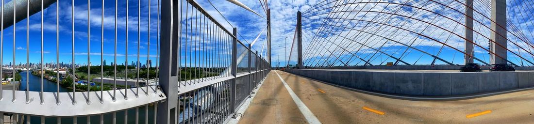 Panoramic view of bridge against blue sky