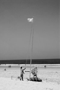 People on beach against sky