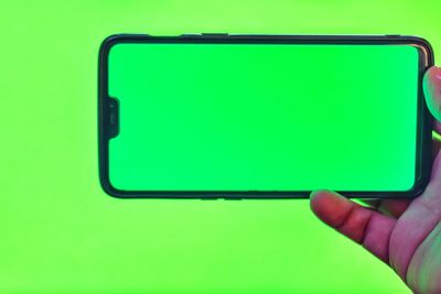 Close-up of hand holding mobile phone