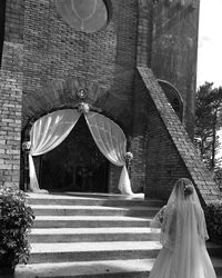 Low angle view of bride standing outside caleruega church