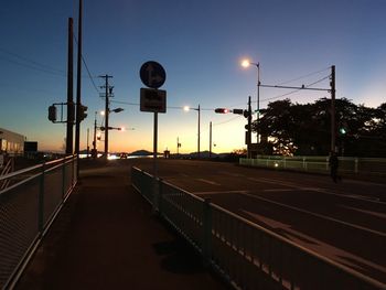 Illuminated street light against sky at night